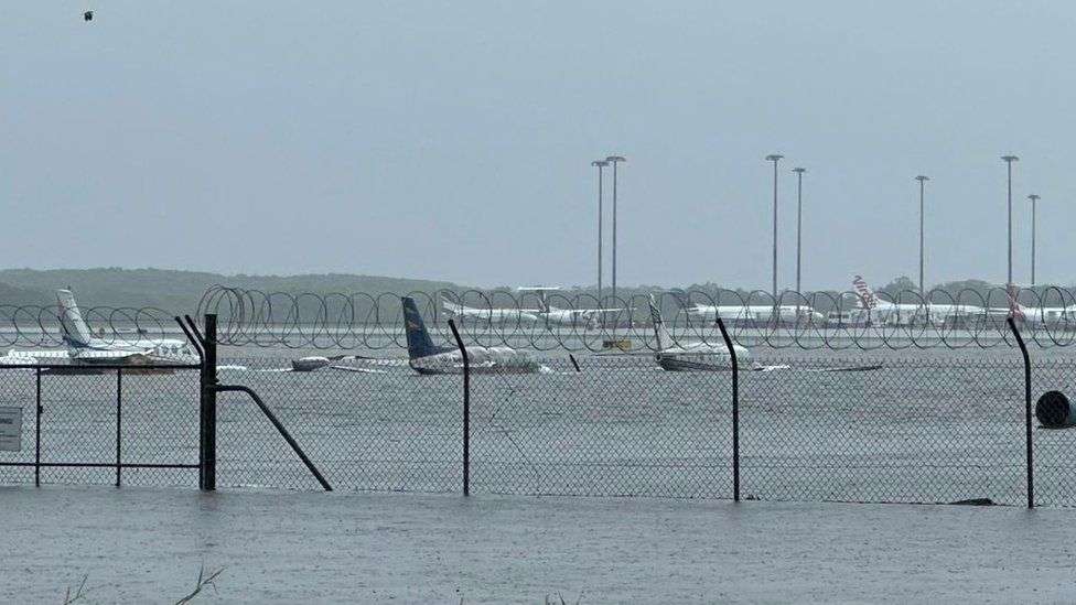 Queensland floods: Airport submerged and crocodiles seen after record rain
