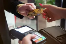 Person with debit card and card payment reader